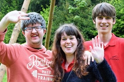 Man with Down syndrome smiling and waving with his family