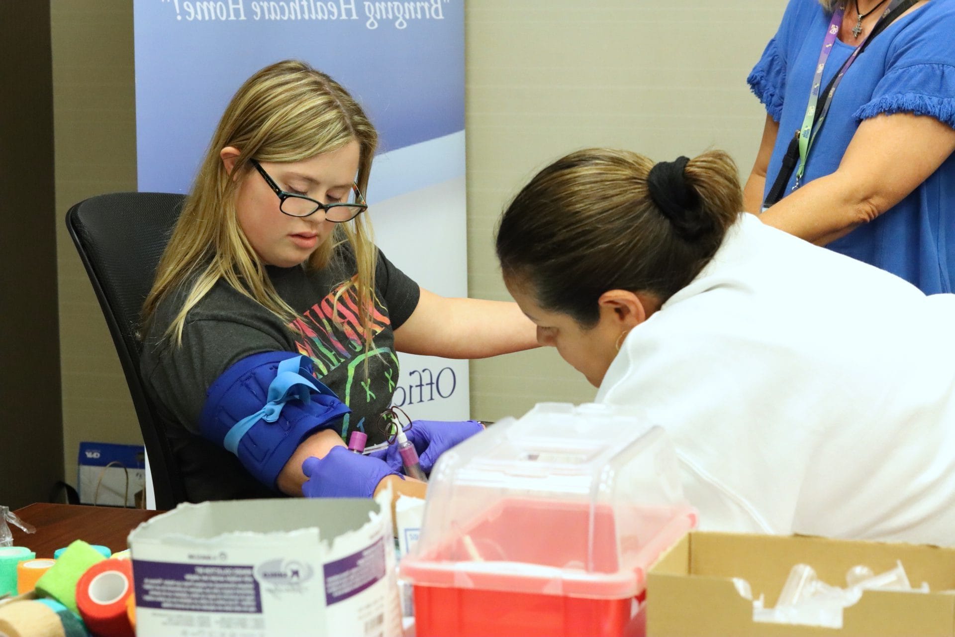 Young woman with Down syndrome giving a blood sample