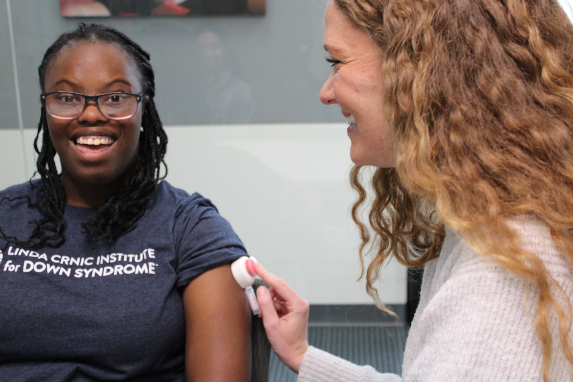 Woman with Down syndrome using the Tasso device with a clinical coordinator
